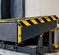 Dock leveler with black and yellow hazard striping